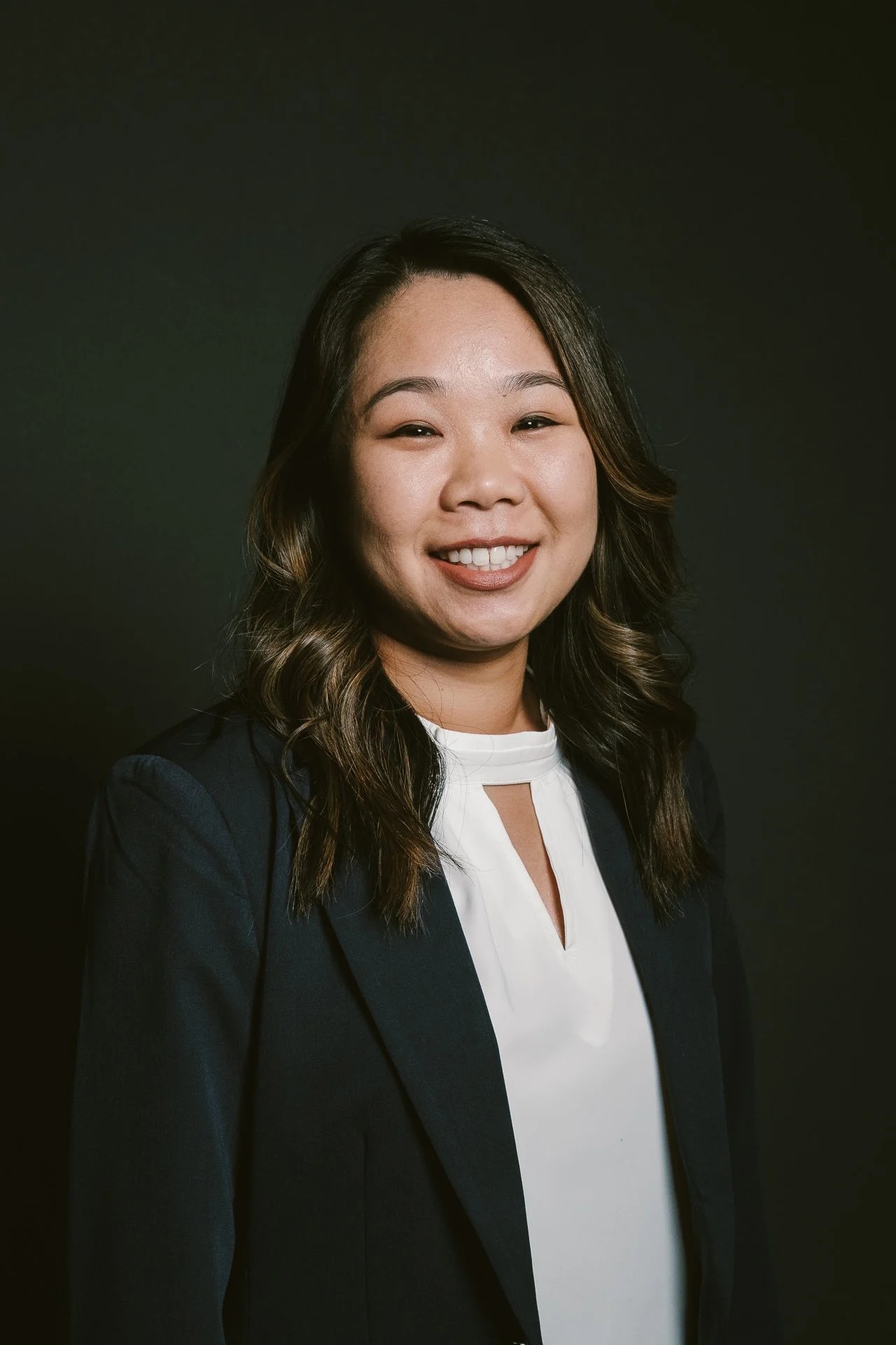 Studio headshot against a dark backdrop