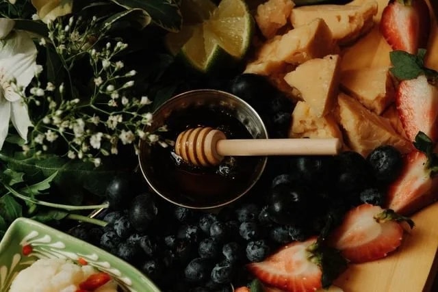 Honey, berries, and cheese — still life