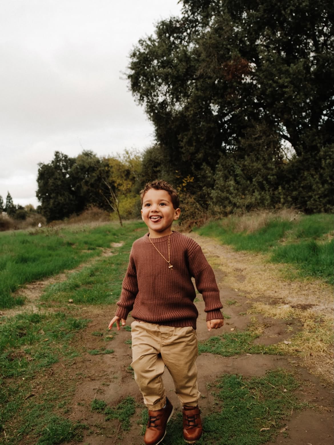 Boy laughing on a dirt path — portrait photography by Steven Lelham in California